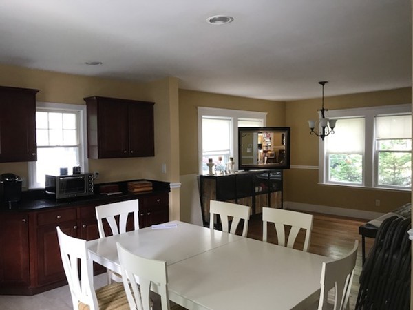 2 Jackson Road Medford, MA 02155 - Photo 10 of 23 a kitchen with a dining table chairs and refrigerator
