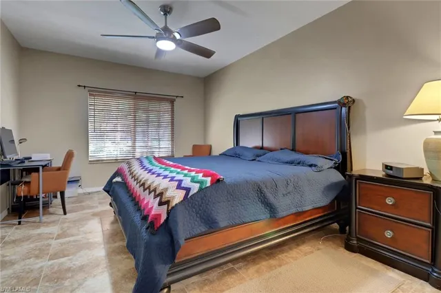 a bedroom with a bed and a desk