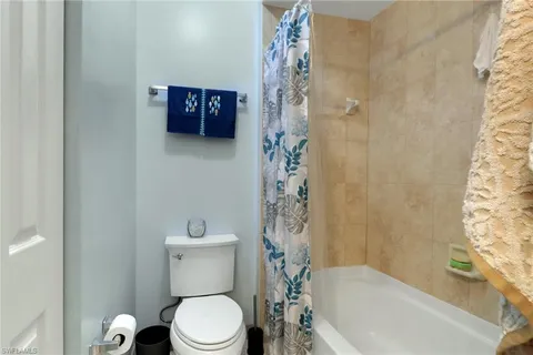 a bathroom with a toilet and a tub