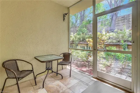 a view of a chairs and table in the balcony