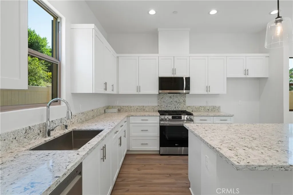 810 Francesca Drive Walnut, CA 91789 - Photo 27 of 33 a kitchen with a sink stove top oven and cabinets