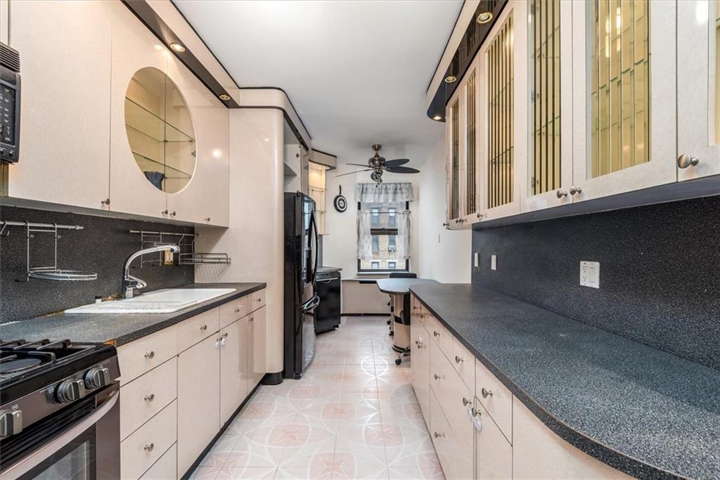 2425 Kings Highway, Unit E16 Brooklyn, NY 11229 - Photo 4 of 11 a kitchen with stainless steel appliances granite countertop a sink and a stove