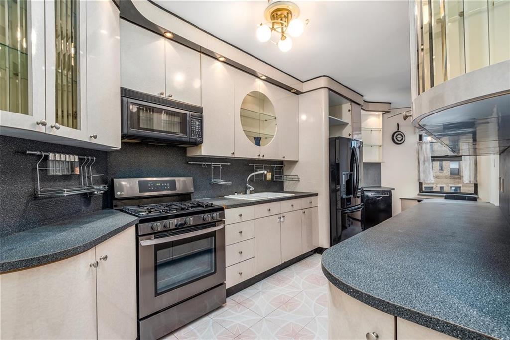 2425 Kings Highway, Unit E16 Brooklyn, NY 11229 - Photo 5 of 11 a kitchen with stainless steel appliances granite countertop a stove a sink and a refrigerator