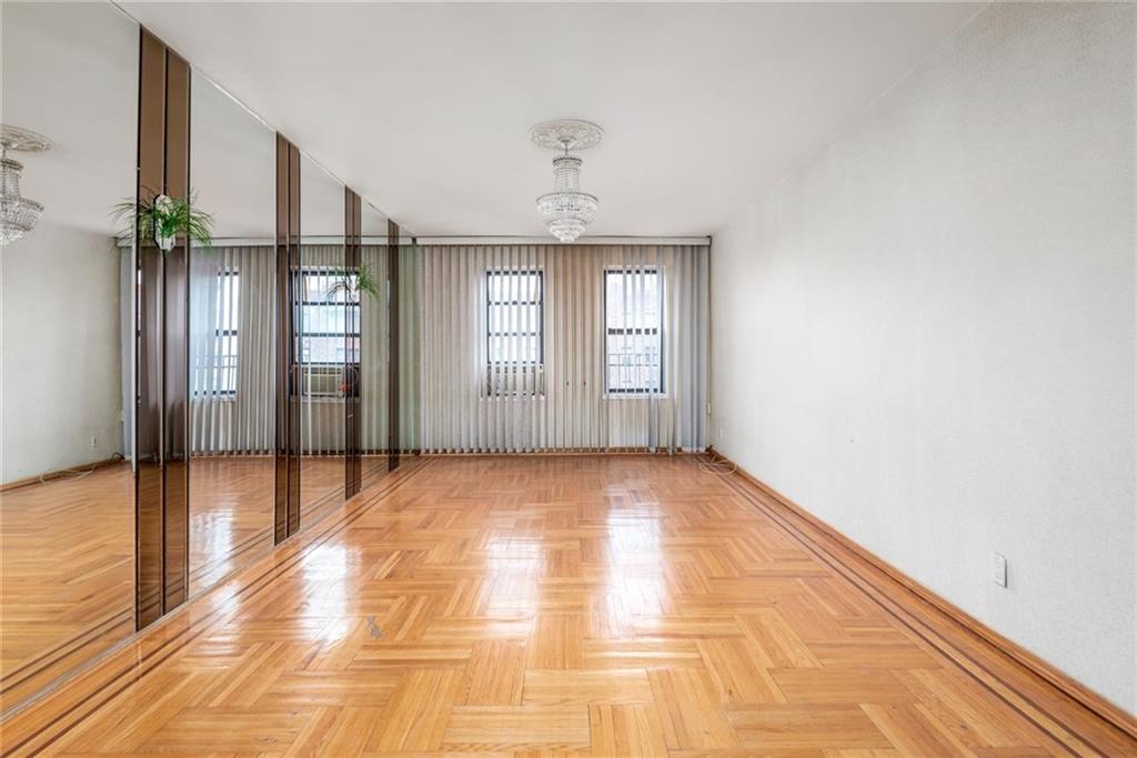 2425 Kings Highway, Unit E16 Brooklyn, NY 11229 - Photo 6 of 11 a view of an empty room with window and wooden floor