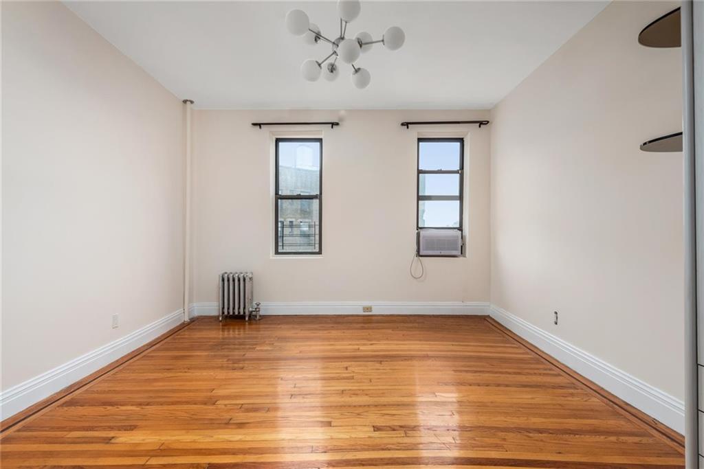 2425 Kings Highway, Unit E16 Brooklyn, NY 11229 - Photo 8 of 11 wooden floor in an empty room with a window