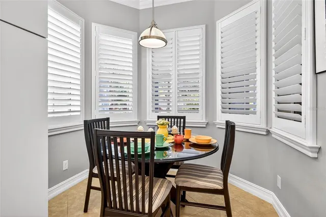 a dining room with furniture a chandelier and window