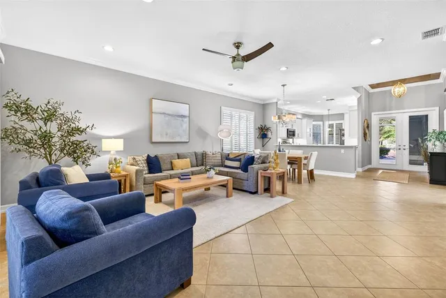 a living room with fireplace furniture and a chandelier