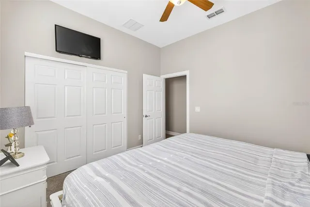 a view of a bedroom with furniture and lamp