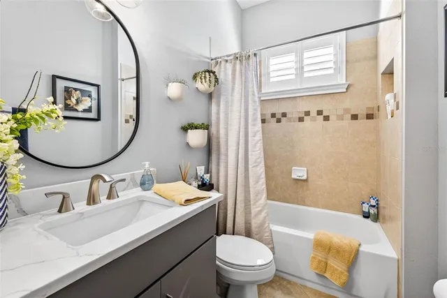 a bathroom with a tub sink and mirror