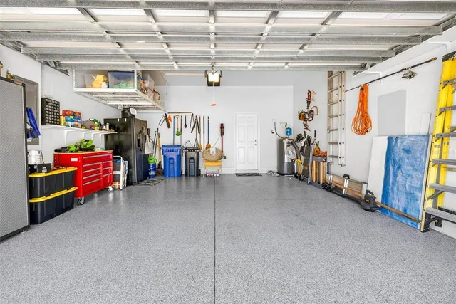 a view of a house with a yard and potted plants
