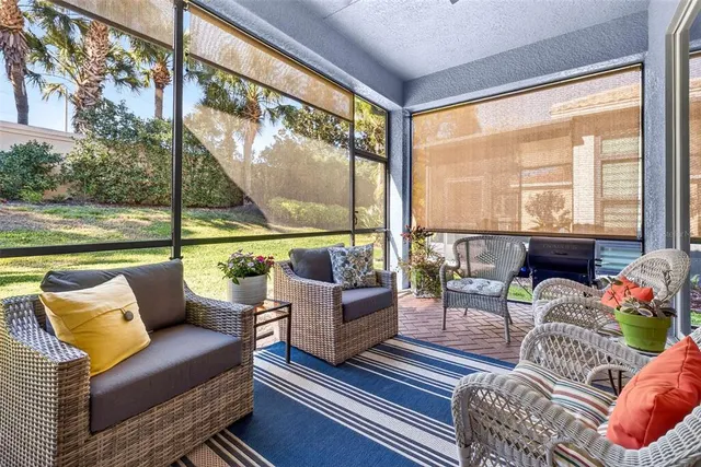 an aerial view of a house with a yard and sitting area