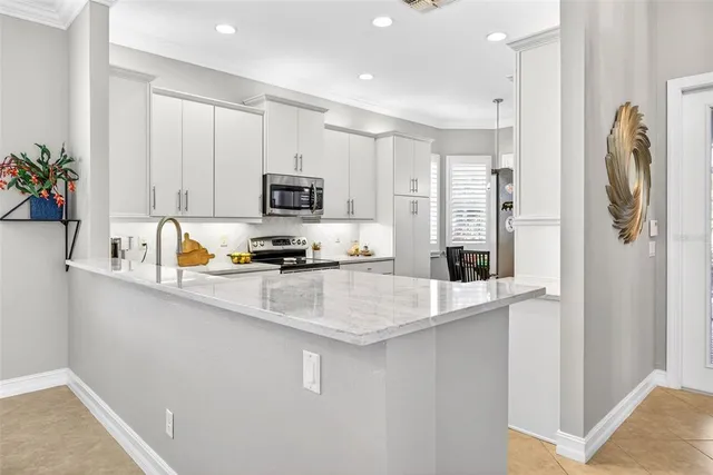a kitchen with appliances a sink and cabinets