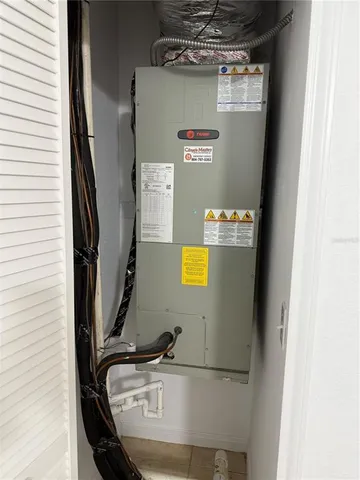 a living room with patio furniture and a floor to ceiling window