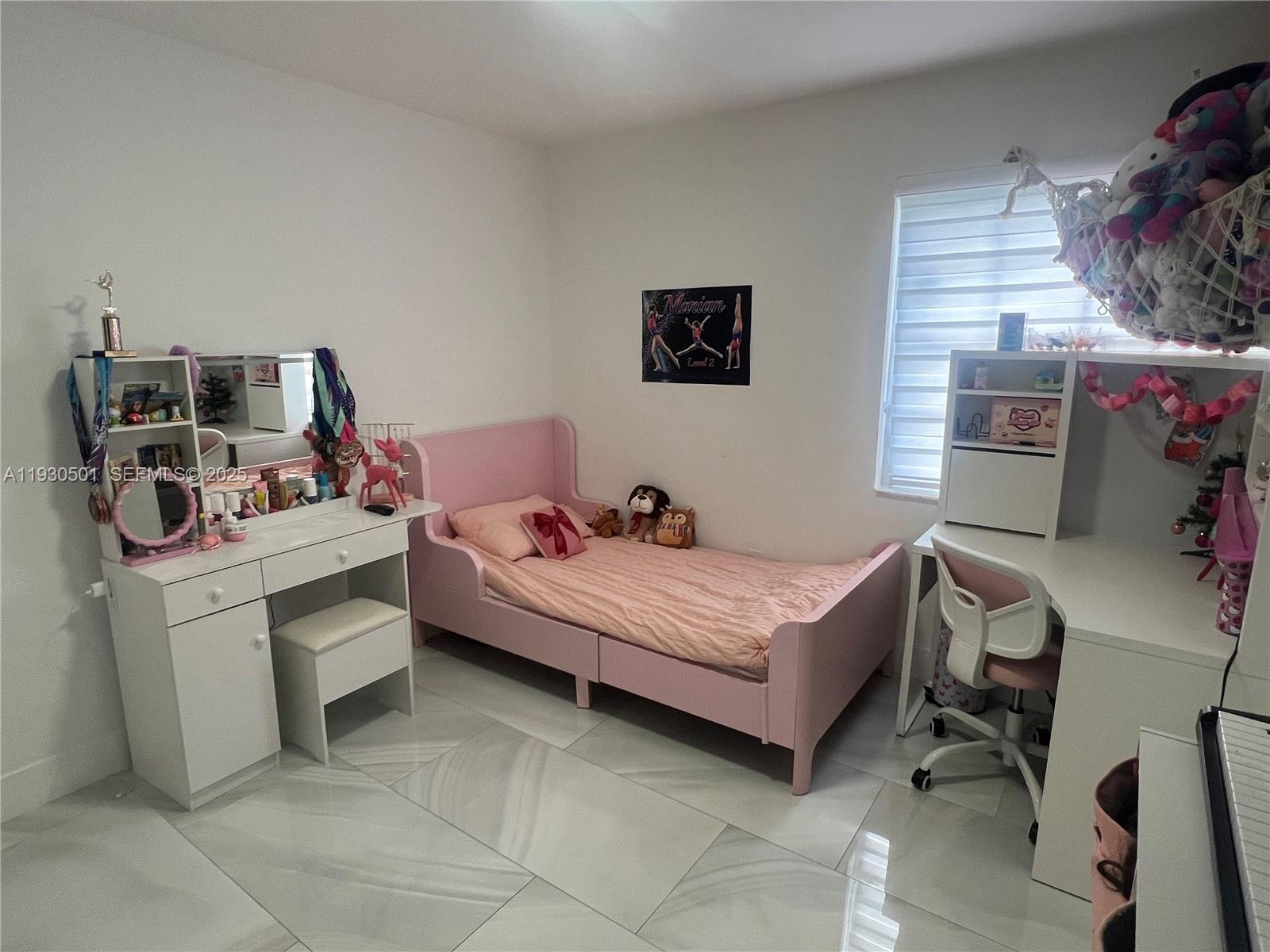 6101 Southwest 153rd Court Road Miami, FL 33193 - Photo 26 of 49 a bedroom with a bed and a desk