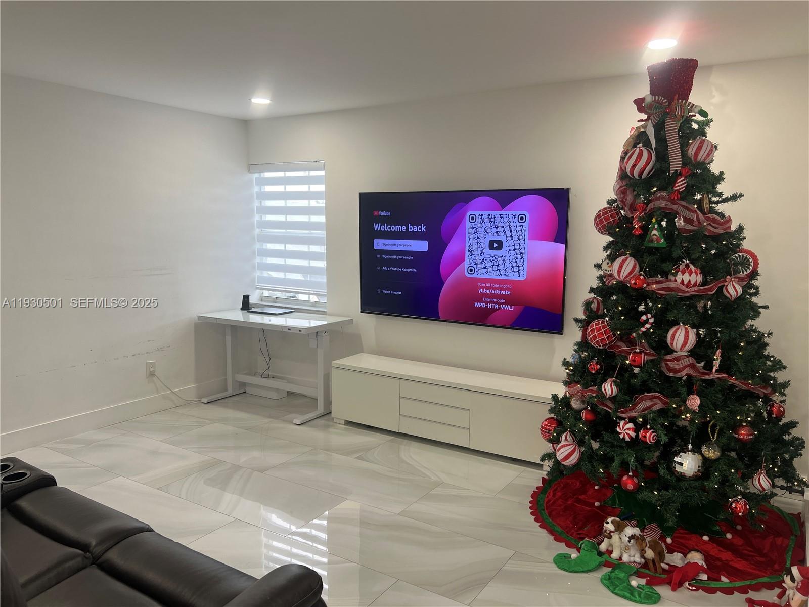 6101 Southwest 153rd Court Road Miami, FL 33193 - Photo 42 of 49 a living room with a couch and a potted plant