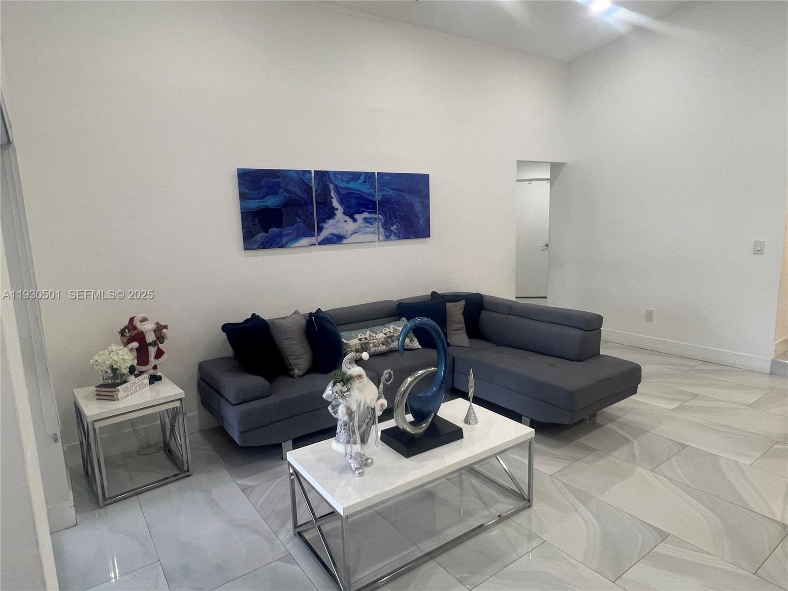 6101 Southwest 153rd Court Road Miami, FL 33193 - Photo 45 of 49 a living room with furniture a couch and white walls