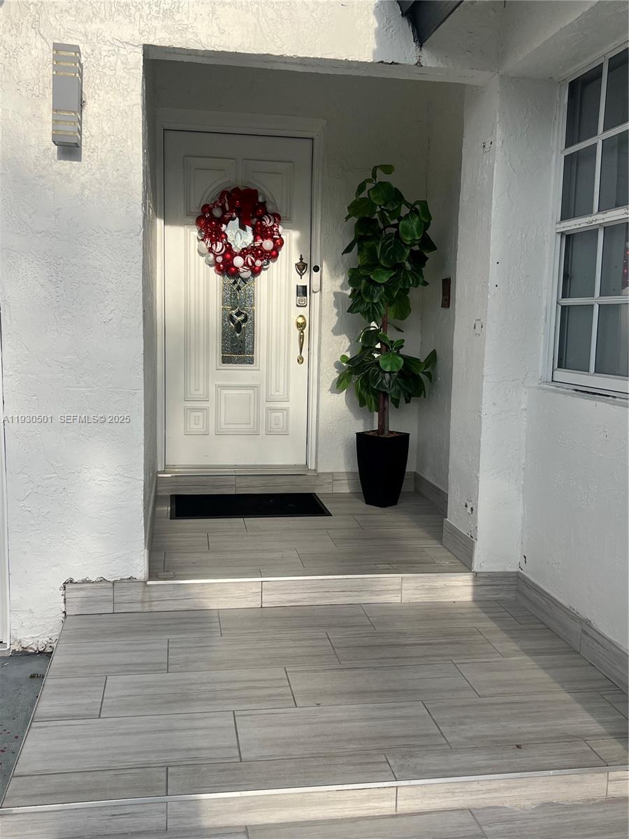6101 Southwest 153rd Court Road Miami, FL 33193 - Photo 47 of 49 a view of a hallway with wooden floor and a potted plant