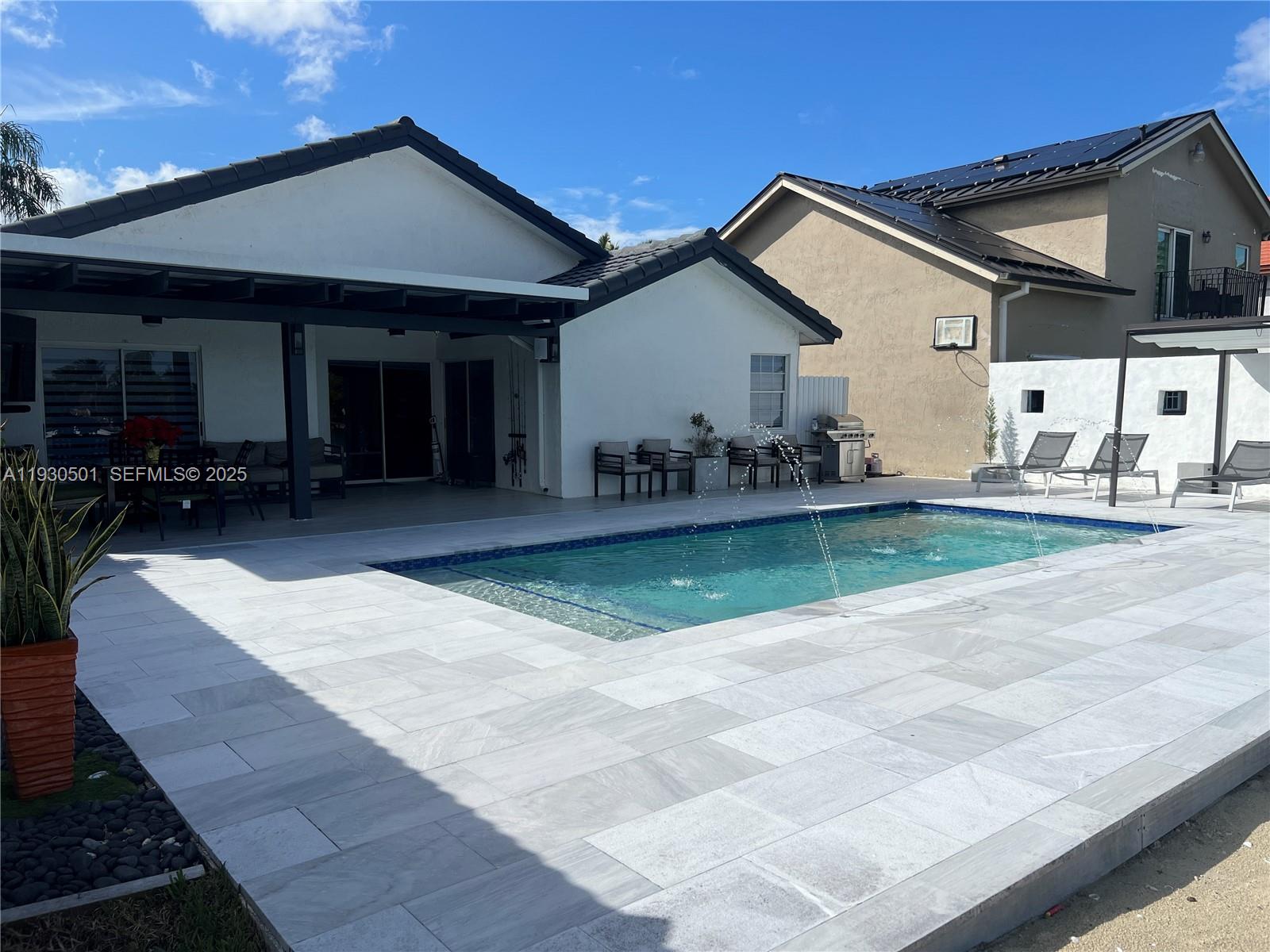 6101 Southwest 153rd Court Road Miami, FL 33193 - Photo 5 of 49 a front view of a house with a yard