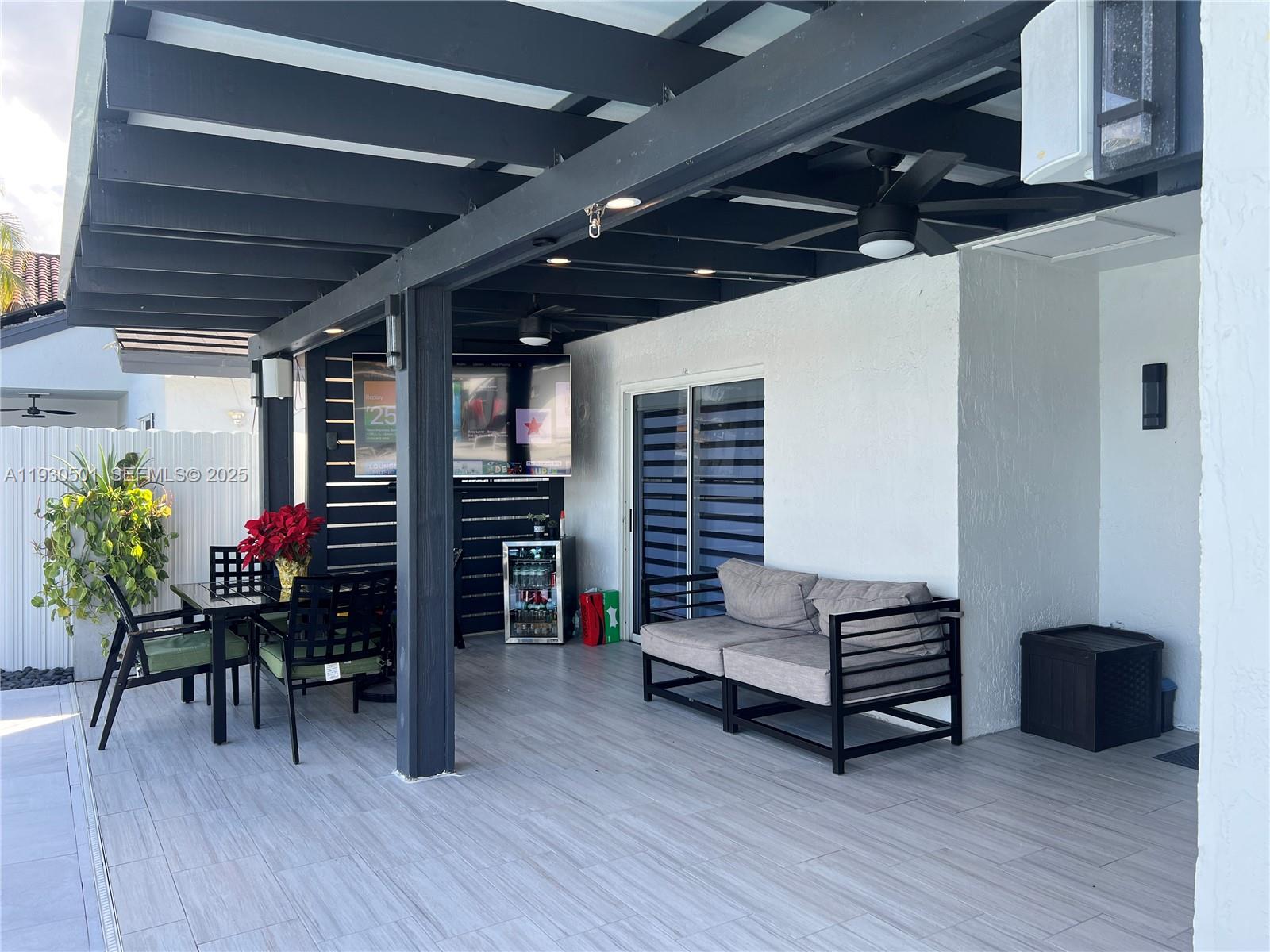 6101 Southwest 153rd Court Road Miami, FL 33193 - Photo 8 of 49 a living room with furniture a wooden floor and potted plant