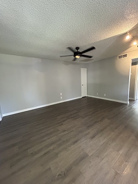 3436 Willowrun Drive, Unit D Austin, TX 78704 - Photo 3 of 9 a view of a room with wooden floor and a ceiling fan