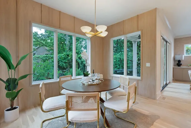 a large kitchen with kitchen island a stove a sink a center island and living room view