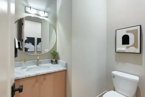 a kitchen with stainless steel appliances granite countertop a table chairs and a large window