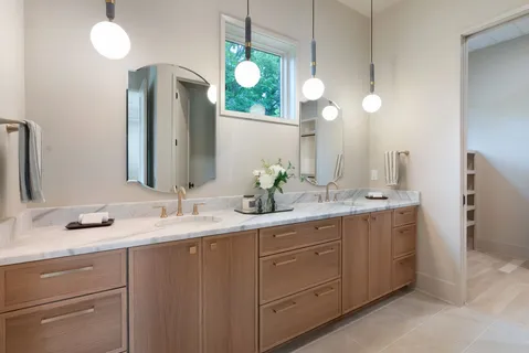 a bathroom with a double vanity sink and mirror