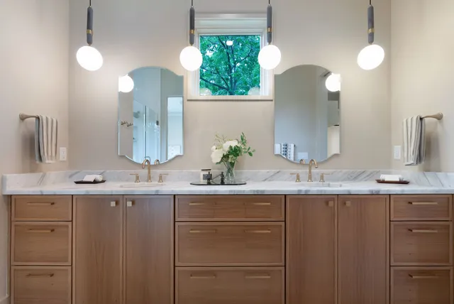 a bathroom with a double vanity sink and mirror