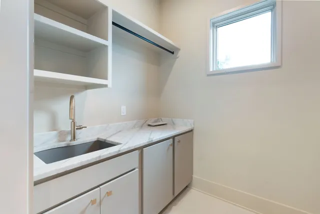 a view of storage and utility room with window