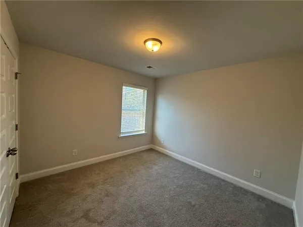 an empty room with windows and entrance