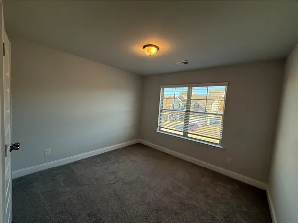 an empty room with a empty space and a window