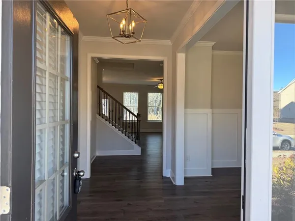 a view of a hallway view with wooden floor and staircase