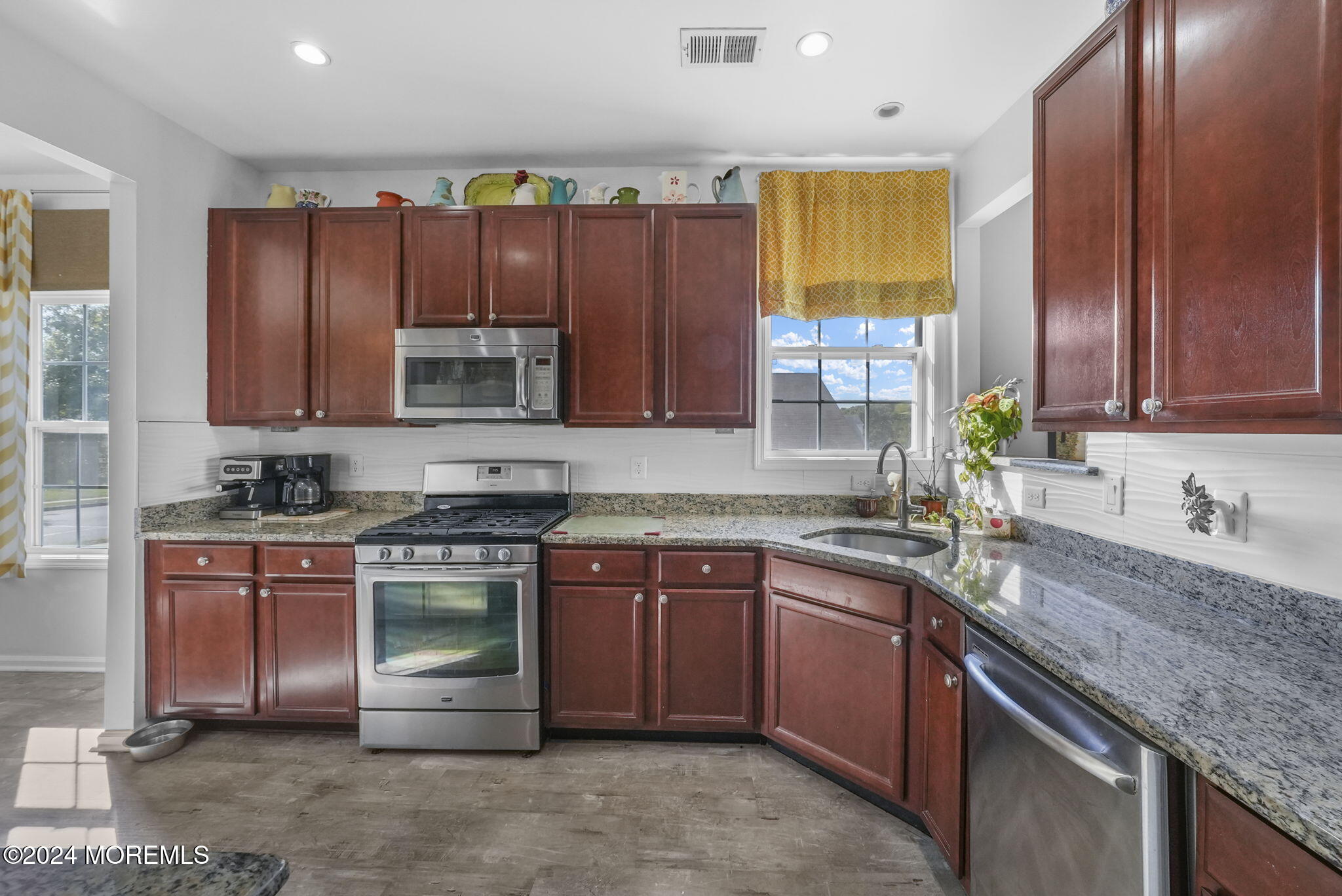 30 Silver Maple Lane Howell, NJ 07731 - Photo 5 of 43 a kitchen with stainless steel appliances granite countertop a sink stove and cabinets