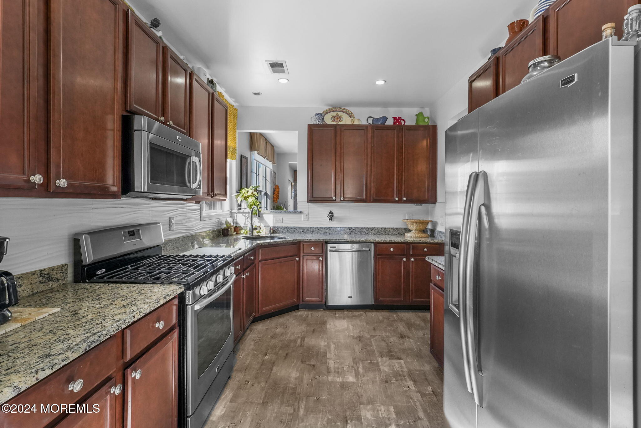 30 Silver Maple Lane Howell, NJ 07731 - Photo 6 of 43 a kitchen with stainless steel appliances granite countertop a refrigerator a stove a sink and a microwave