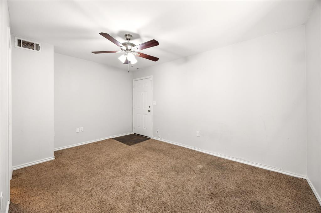 9837 Walnut Street, Unit S203 Dallas, TX 75243 - Photo 17 of 26 This room features soft brown carpeting, a white entry door, and a ceiling fan with light fixture