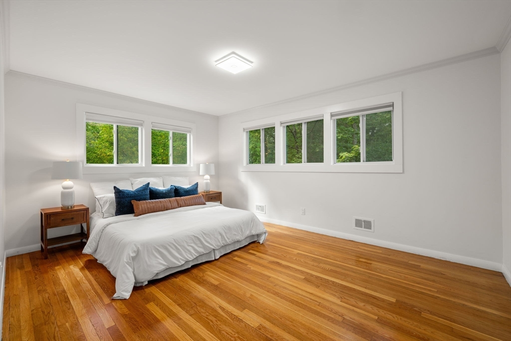 324 Nashoba Road Concord, MA 01742 - Photo 12 of 25 a bedroom with a bed and wooden floor