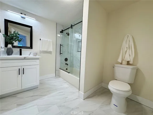 a bathroom with a toilet sink and shower