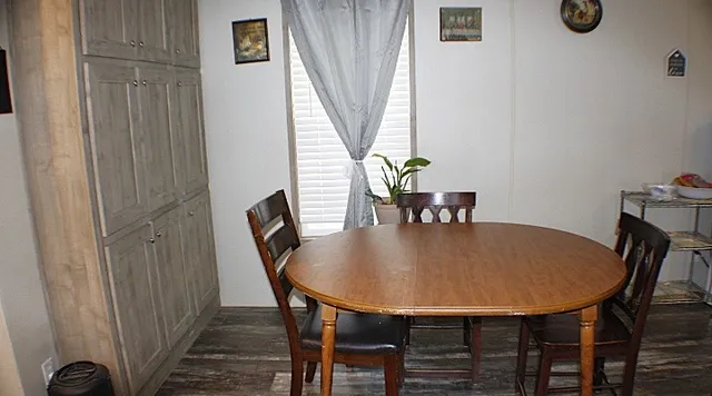 a dining room with furniture and window