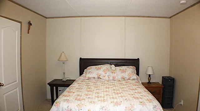 a bedroom with a bed and a table