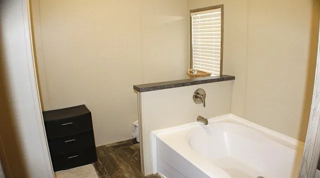 a bathroom with a bathtub and a window