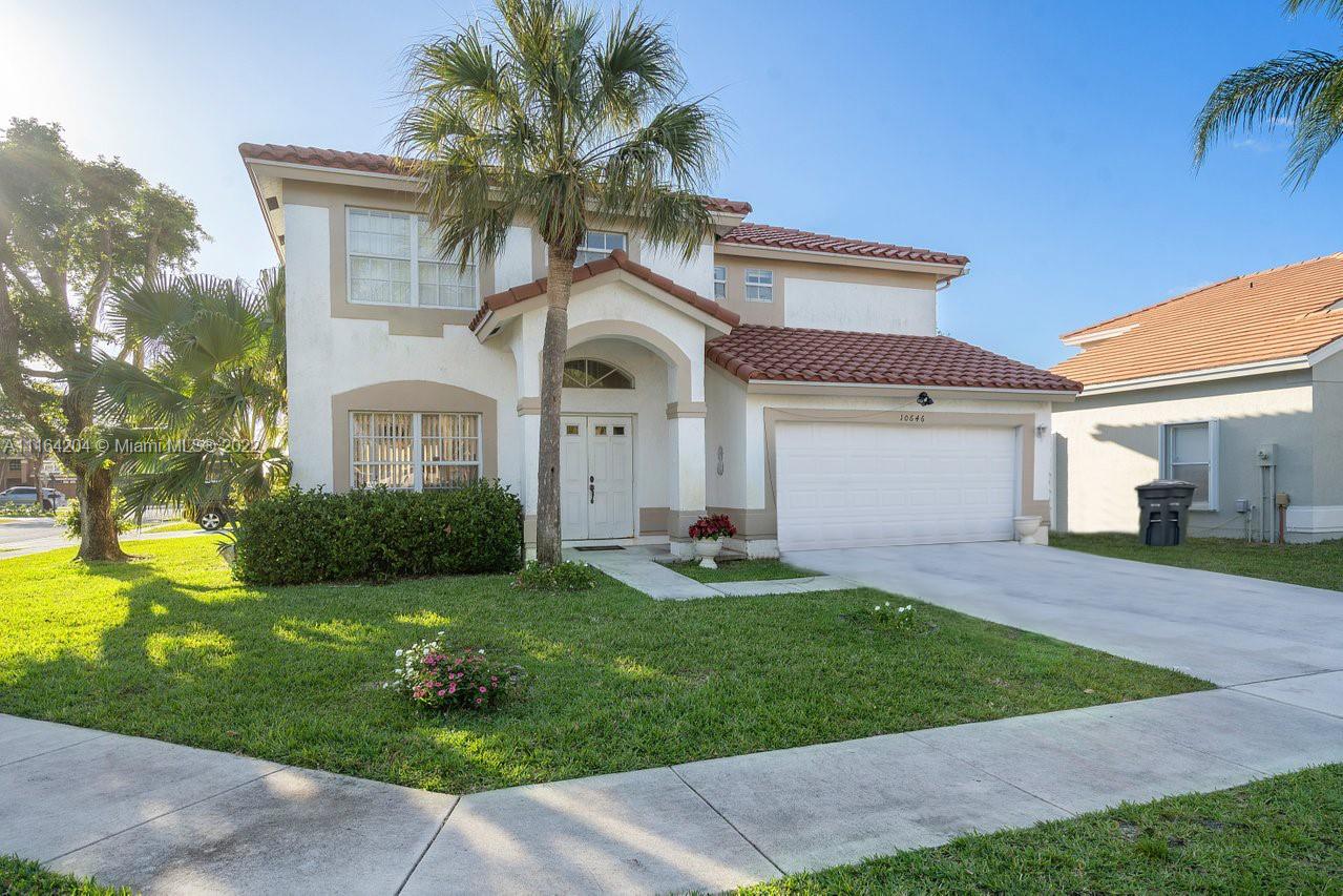 a front view of a house with a yard and garage