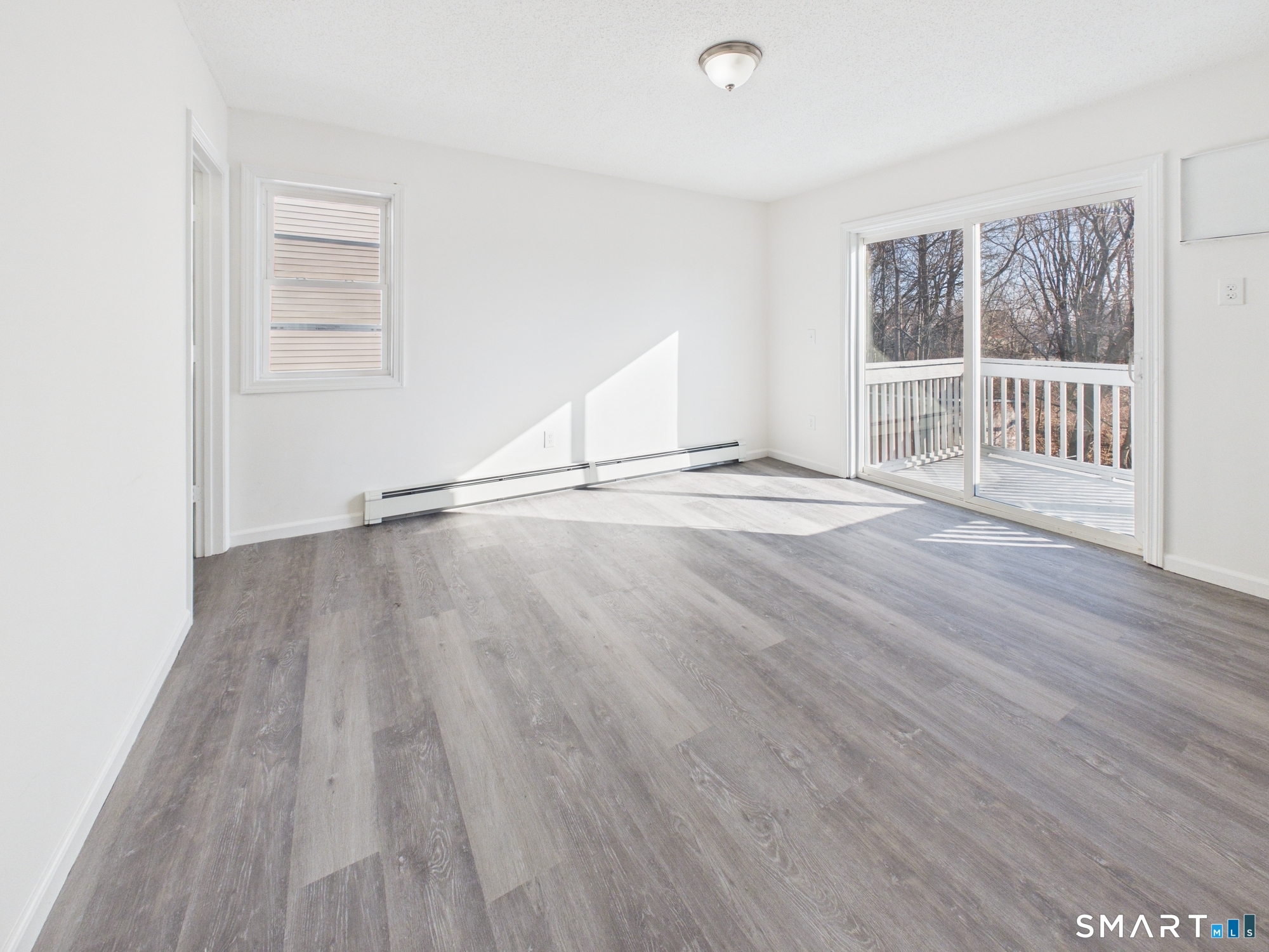 23 Dewitt Street New Haven, CT 06519 - Photo 17 of 36 an empty room with wooden floor and windows