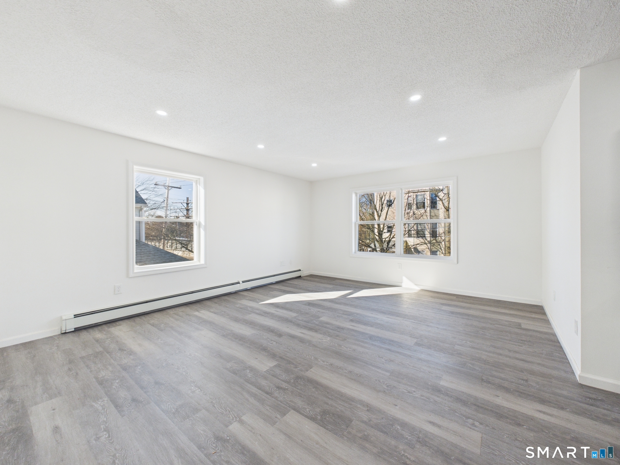 23 Dewitt Street New Haven, CT 06519 - Photo 20 of 36 a view of an empty room with wooden floor and a window