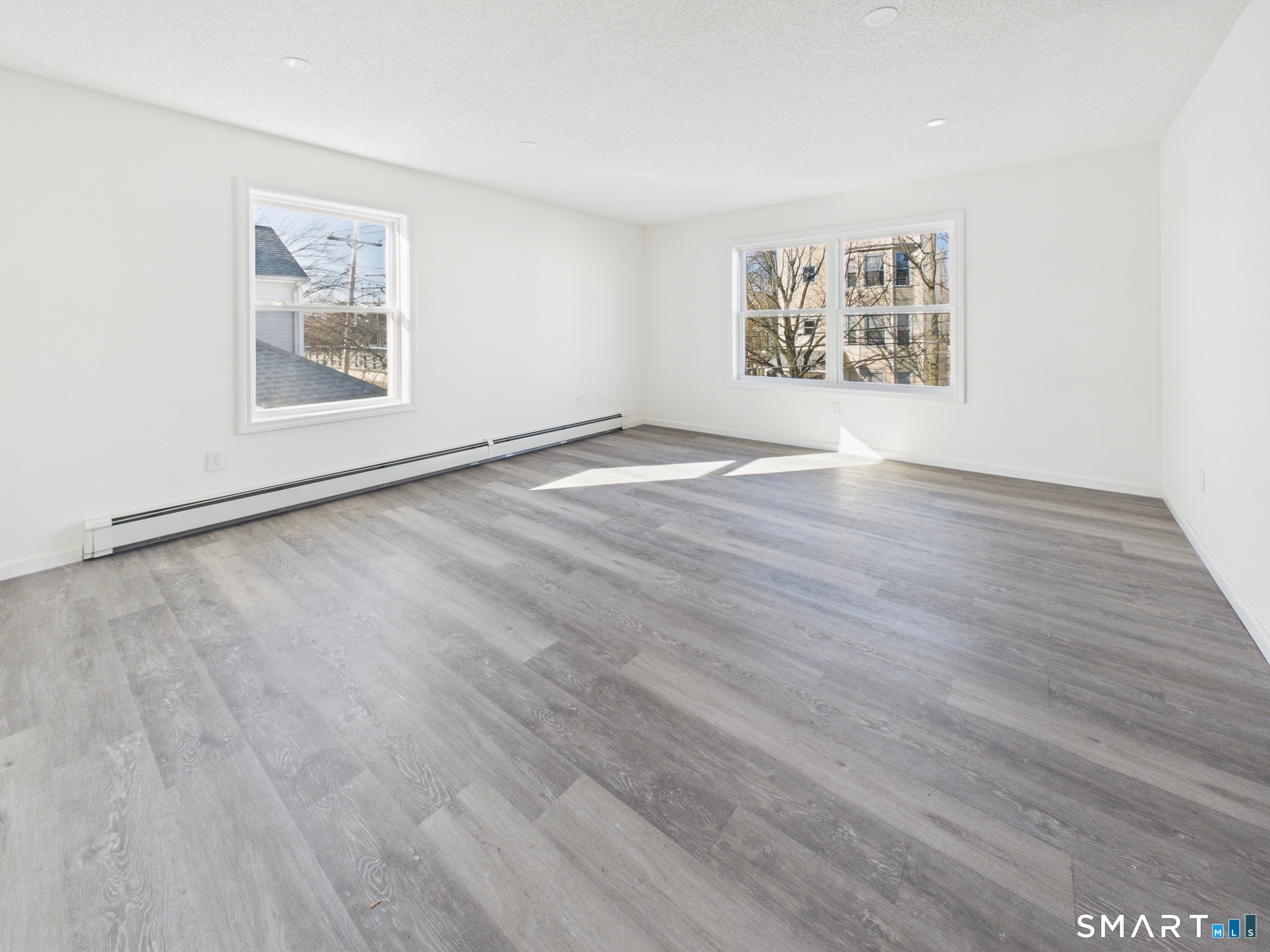 23 Dewitt Street New Haven, CT 06519 - Photo 22 of 36 an empty room with wooden floor and windows