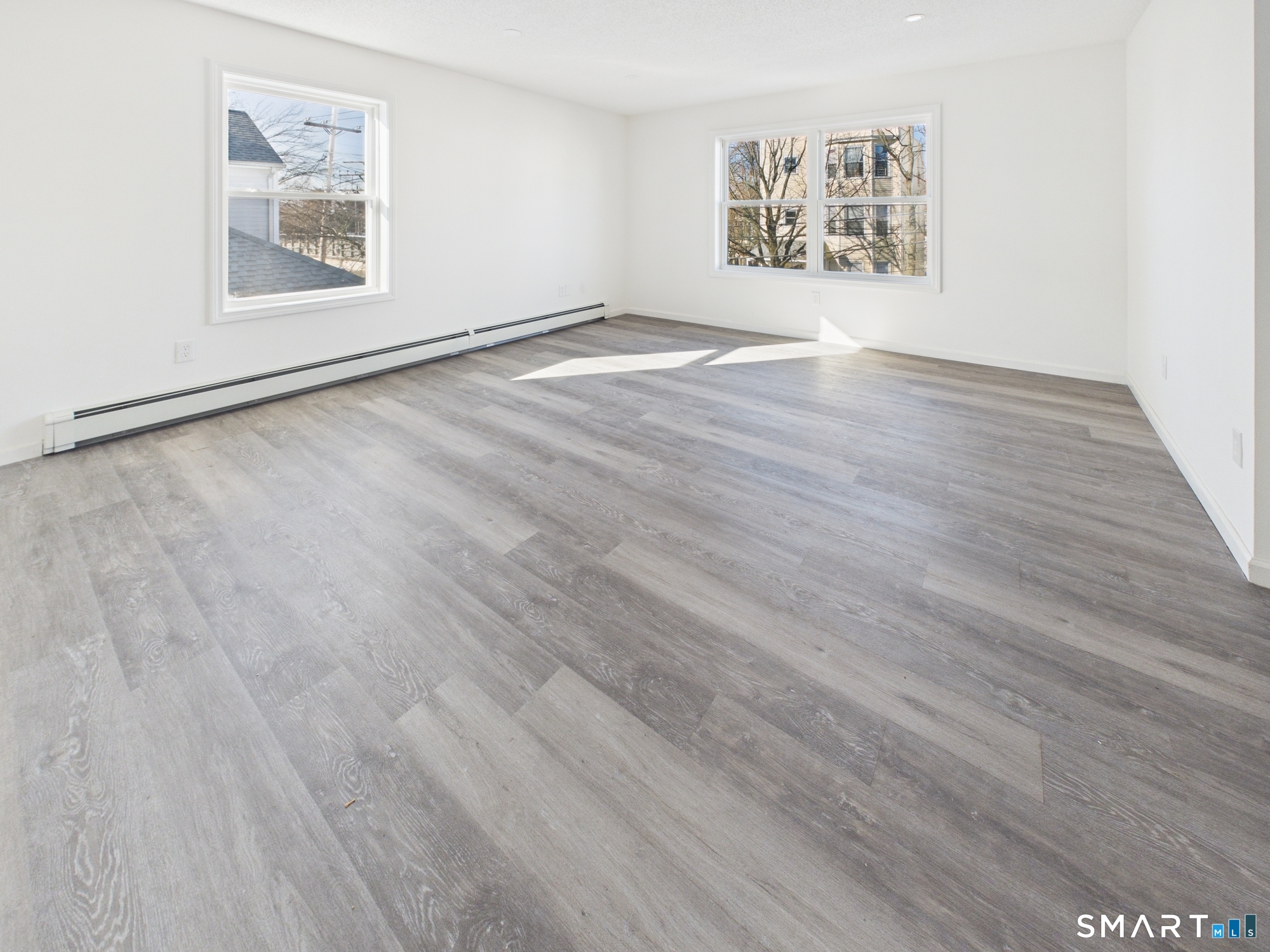 23 Dewitt Street New Haven, CT 06519 - Photo 23 of 36 an empty room with wooden floor and windows