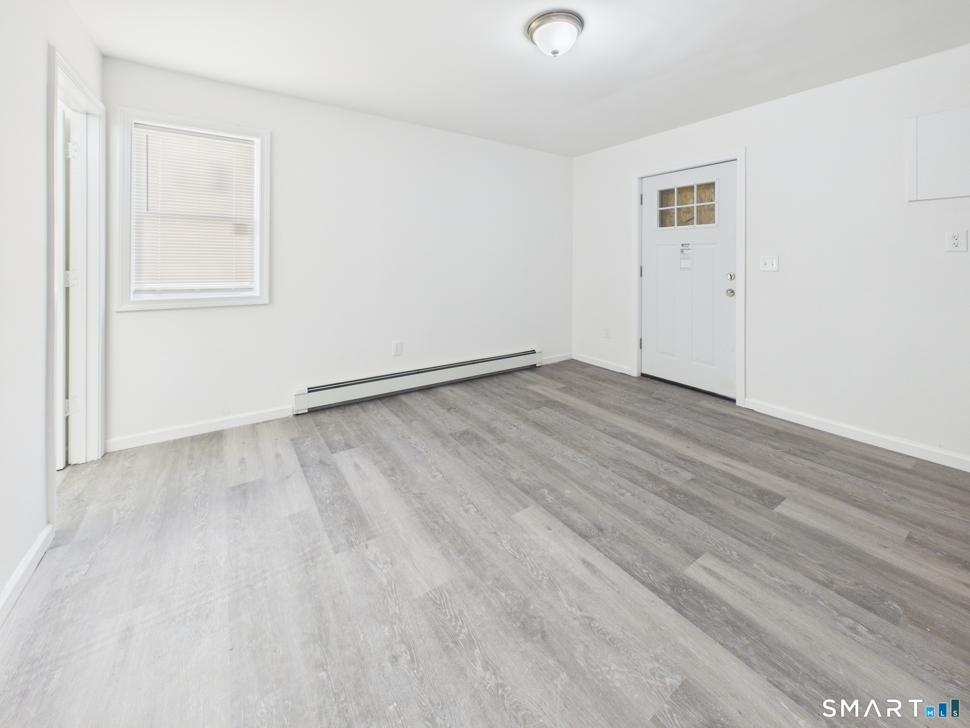23 Dewitt Street New Haven, CT 06519 - Photo 24 of 36 an empty room with wooden floor and windows