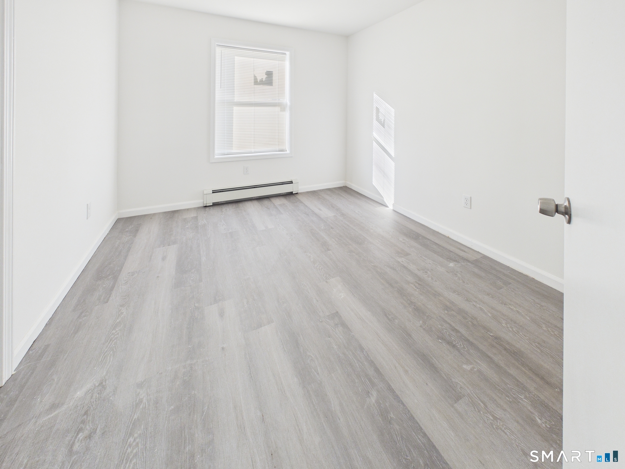 23 Dewitt Street New Haven, CT 06519 - Photo 25 of 36 an empty room with wooden floor and windows