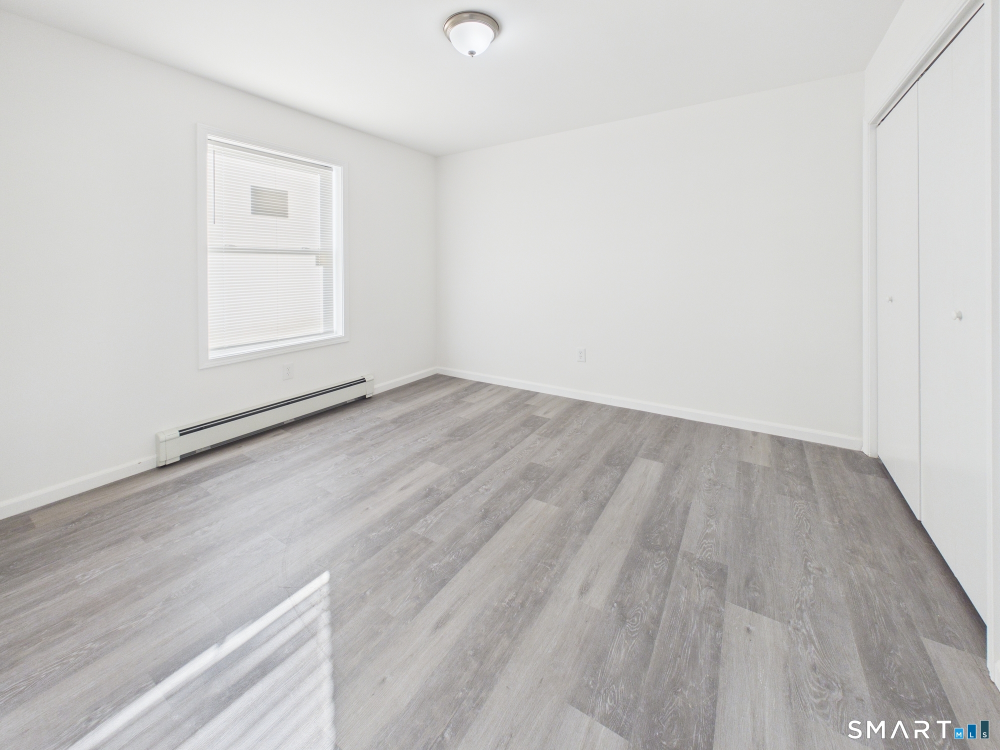 23 Dewitt Street New Haven, CT 06519 - Photo 33 of 36 an empty room with wooden floor and windows