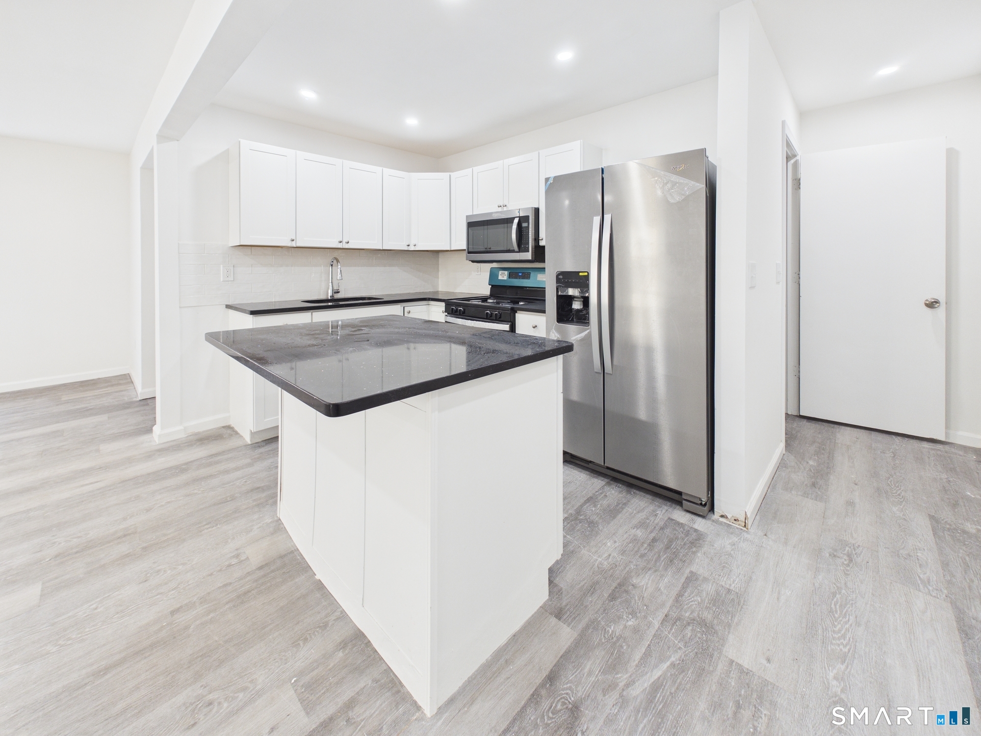 23 Dewitt Street New Haven, CT 06519 - Photo 35 of 36 a kitchen with stainless steel appliances granite countertop a refrigerator a sink and a stove