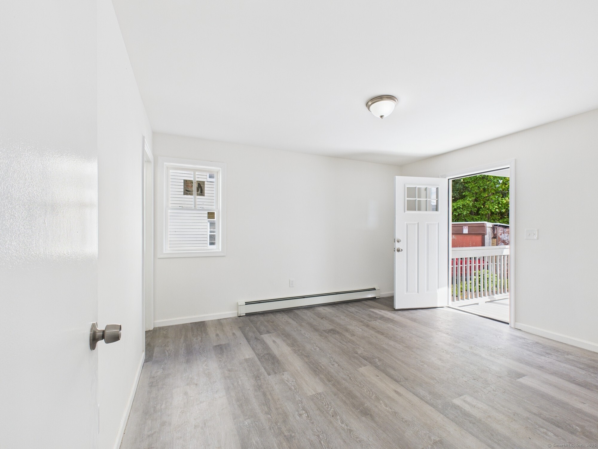 23 Dewitt Street New Haven, CT 06519 - Photo 4 of 36 an empty room with wooden floor and windows